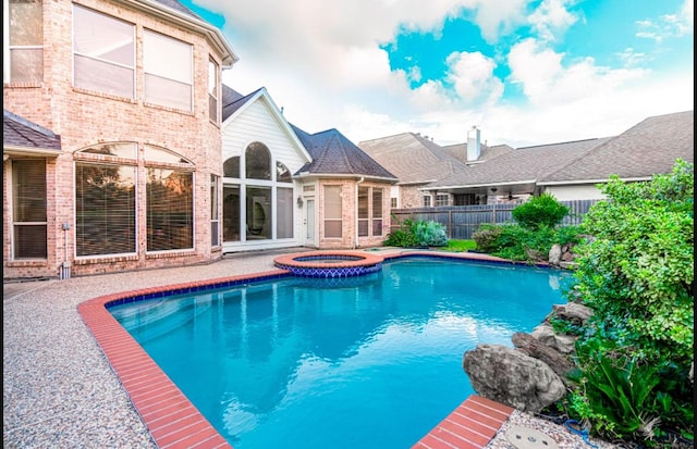 view of swimming pool featuring an in ground hot tub