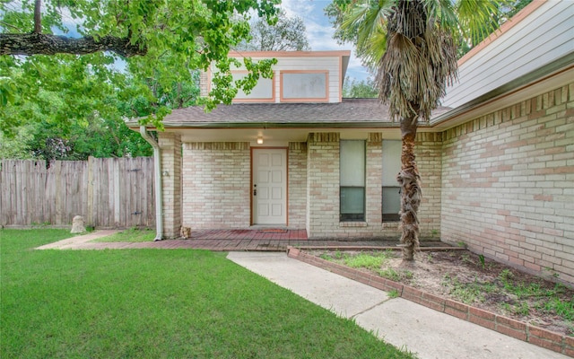 doorway to property featuring a lawn