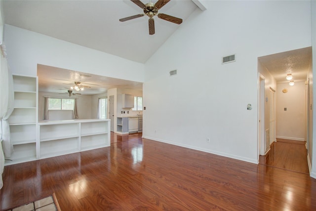 unfurnished living room with ceiling fan, high vaulted ceiling, and hardwood / wood-style flooring