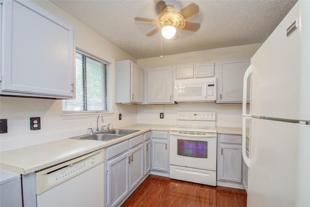 kitchen with a textured ceiling, white appliances, sink, white cabinets, and dark hardwood / wood-style floors