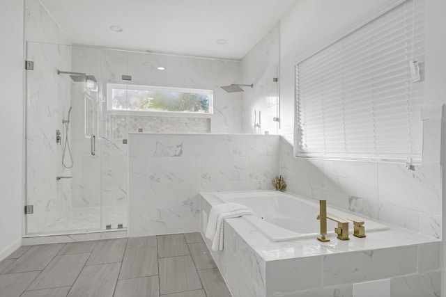 bathroom with separate shower and tub