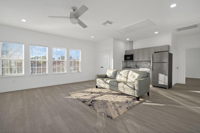 living room featuring hardwood / wood-style floors and ceiling fan