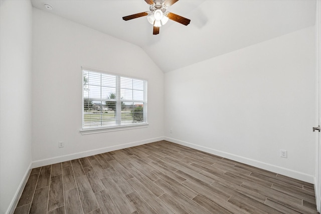 spare room featuring hardwood / wood-style floors, ceiling fan, and lofted ceiling