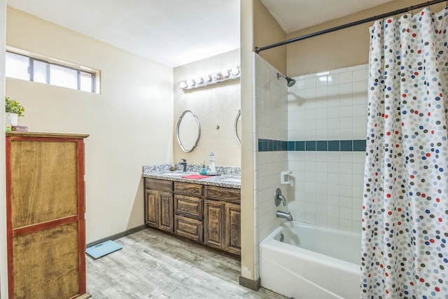 bathroom featuring hardwood / wood-style floors, vanity, and shower / bath combination with curtain