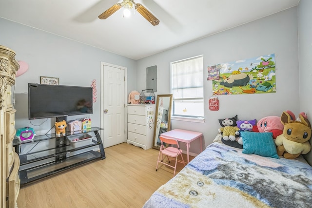 bedroom with electric panel, ceiling fan, and hardwood / wood-style flooring