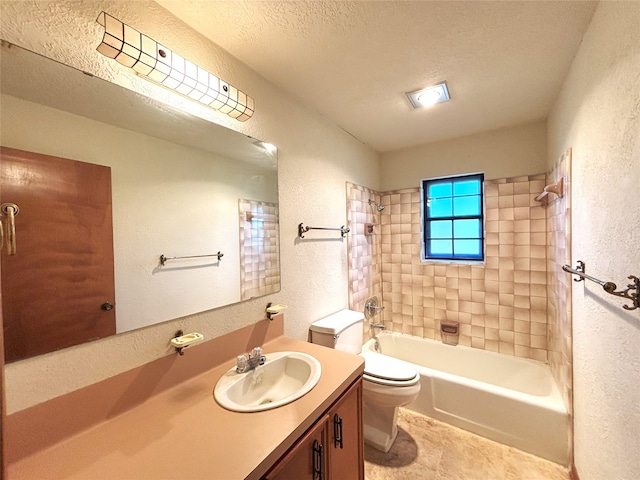 full bathroom featuring vanity, a textured ceiling, tile patterned flooring, toilet, and tiled shower / bath