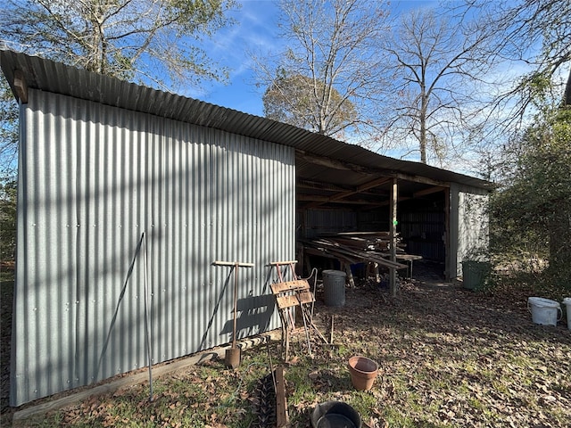 view of property exterior with an outdoor structure