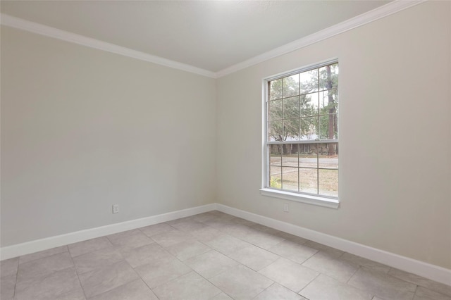 tiled empty room featuring a healthy amount of sunlight and crown molding