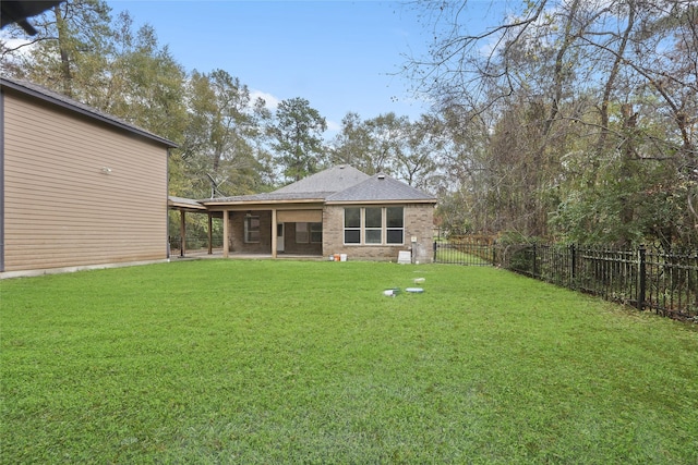 rear view of property with a lawn