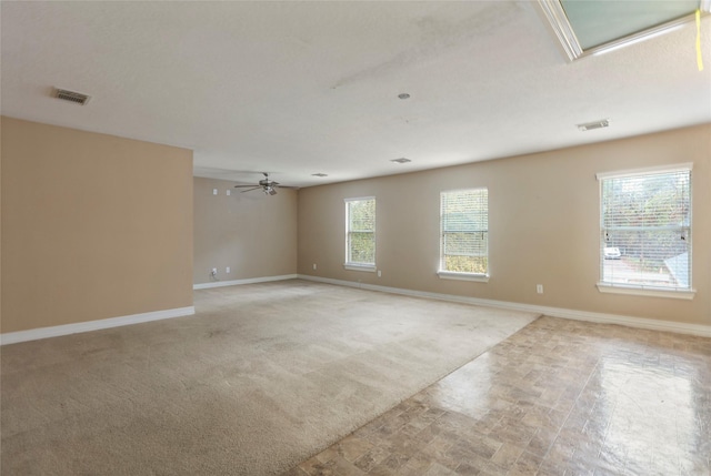 empty room featuring light carpet and ceiling fan