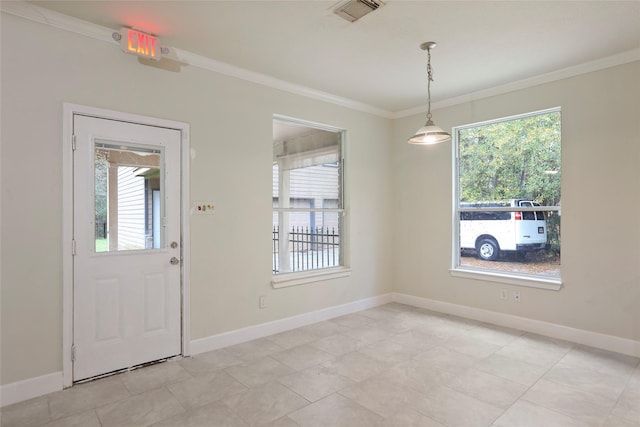 foyer featuring crown molding and a healthy amount of sunlight