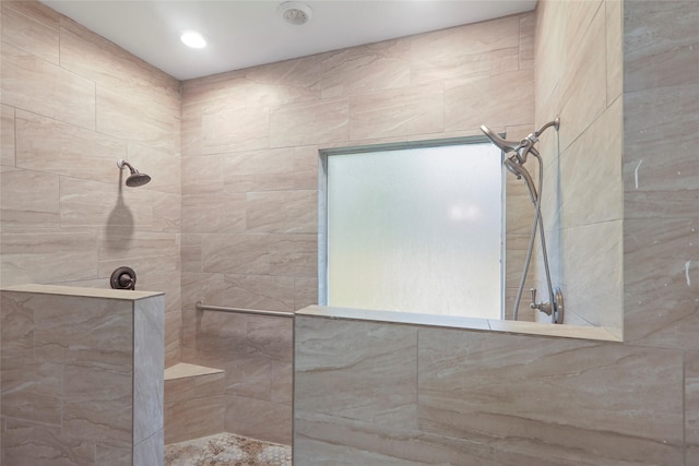 bathroom with tiled shower