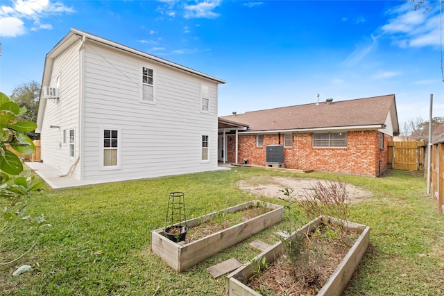 back of house featuring a patio area, cooling unit, and a lawn