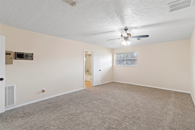 carpeted spare room featuring ceiling fan and a textured ceiling