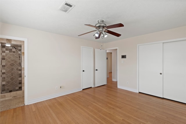 unfurnished bedroom featuring ceiling fan, connected bathroom, and light hardwood / wood-style floors