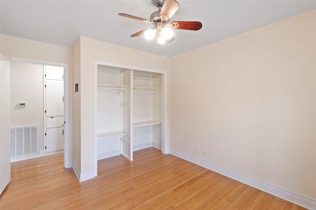 unfurnished bedroom with ceiling fan, a closet, and light hardwood / wood-style flooring