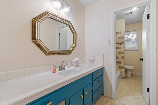 bathroom featuring toilet and vanity