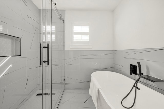 bathroom with separate shower and tub