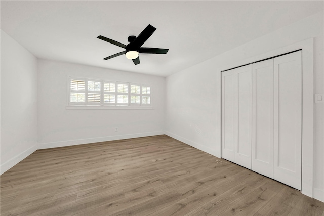 unfurnished bedroom with ceiling fan, light hardwood / wood-style floors, and a closet