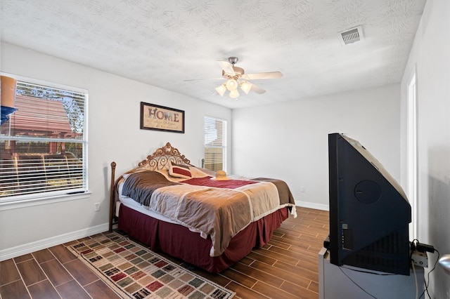 bedroom featuring a textured ceiling and ceiling fan