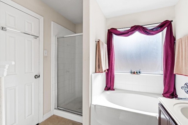 bathroom with vanity and independent shower and bath