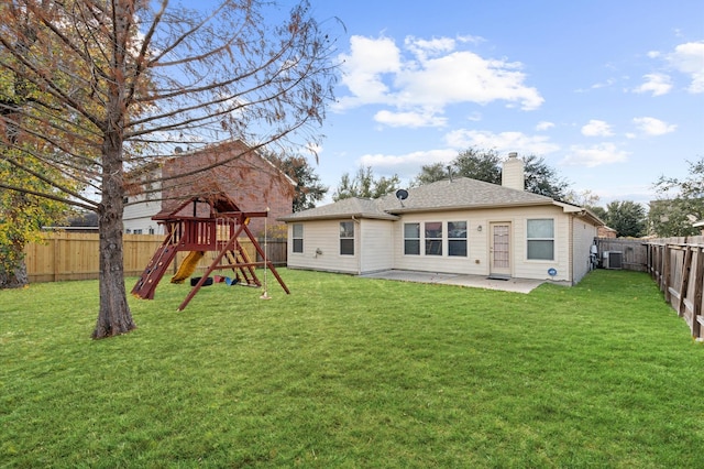 back of house with a playground, a lawn, and a patio