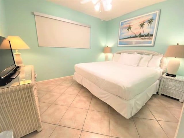 tiled bedroom with ceiling fan