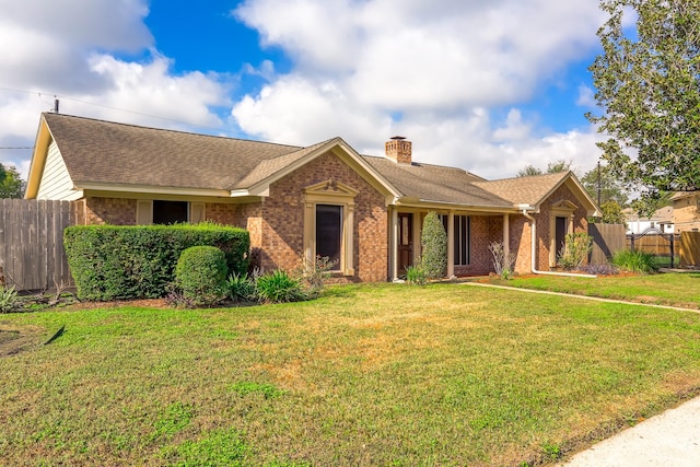 single story home featuring a front lawn