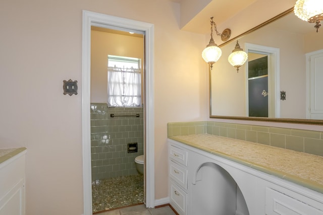 bathroom featuring vanity, toilet, and walk in shower