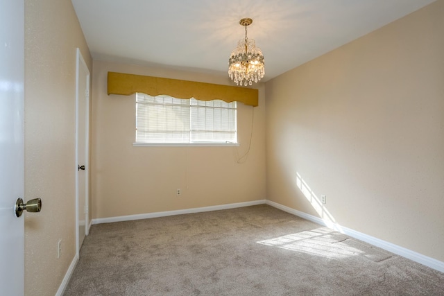 carpeted empty room with a chandelier