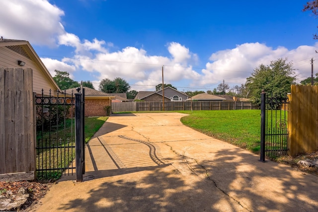 view of gate featuring a yard