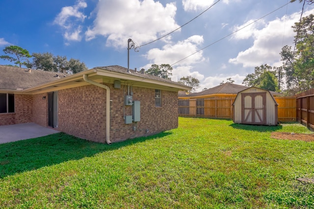 view of yard with a storage unit and a patio