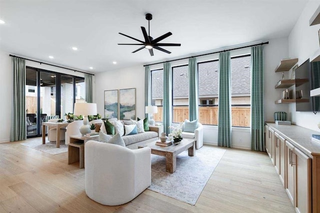 living room featuring ceiling fan and light wood-type flooring