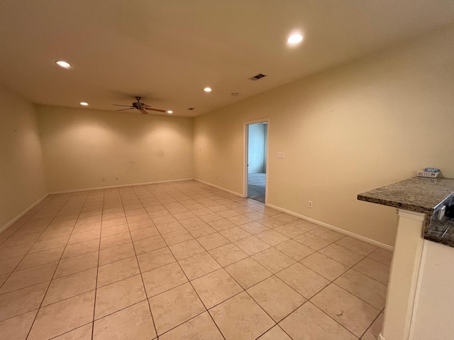 empty room featuring ceiling fan and light tile patterned floors