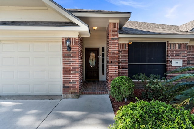 view of exterior entry with a garage