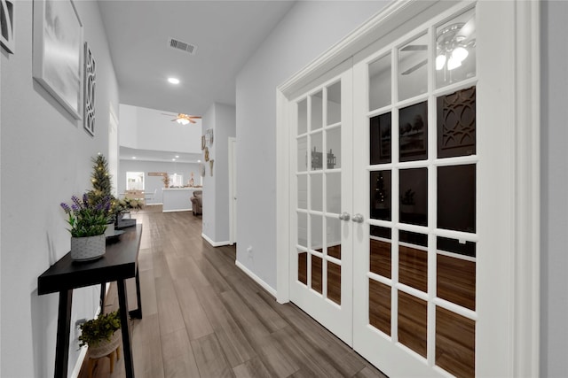 hallway featuring hardwood / wood-style flooring and french doors