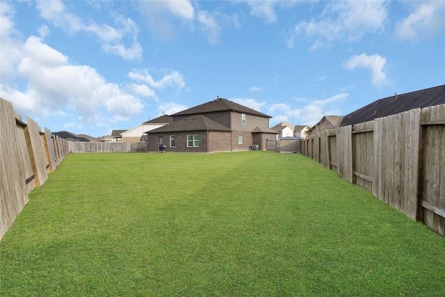 view of yard with a fenced backyard