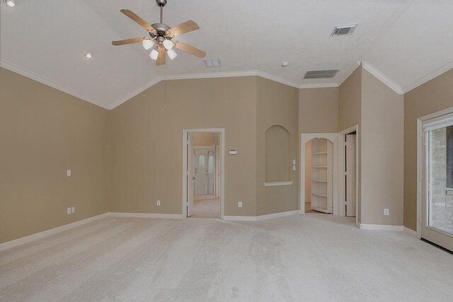 interior space with visible vents, baseboards, crown molding, lofted ceiling, and light colored carpet