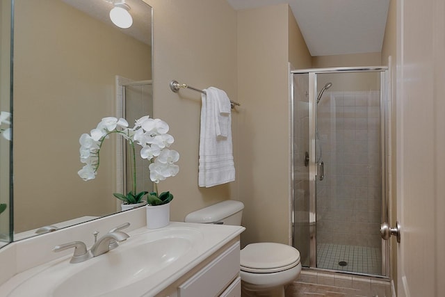 bathroom with vanity, toilet, and a stall shower