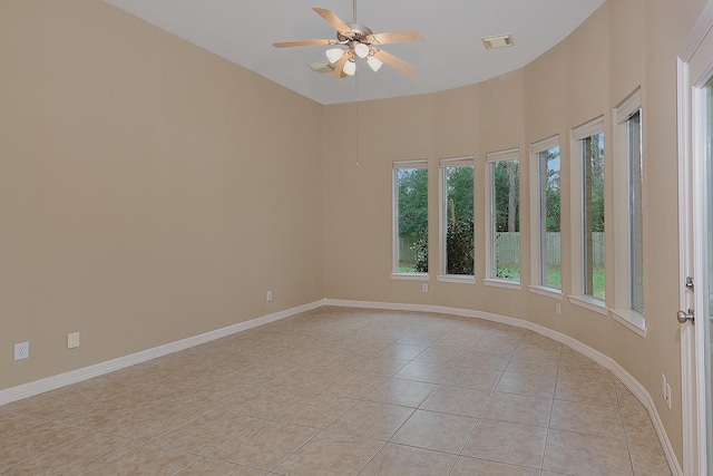 unfurnished room featuring light tile patterned floors, visible vents, and baseboards