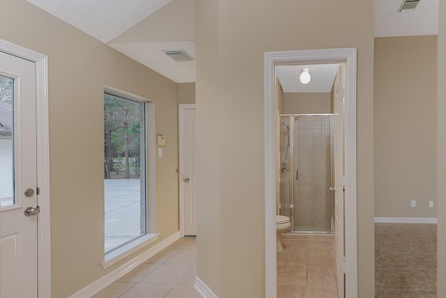 bathroom featuring visible vents, toilet, a stall shower, and tile patterned flooring