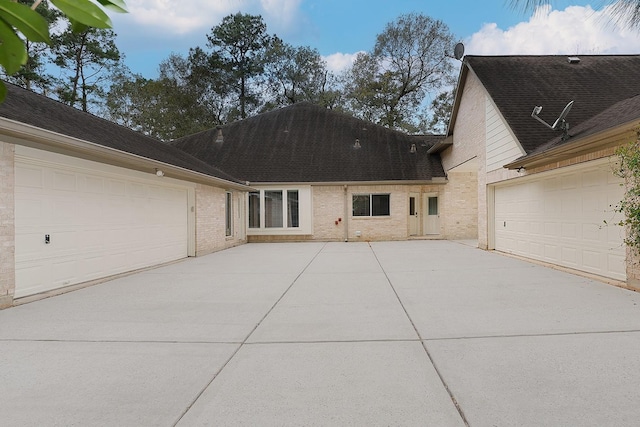 view of front of property with brick siding and roof with shingles