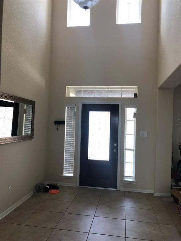 tiled entryway featuring a high ceiling