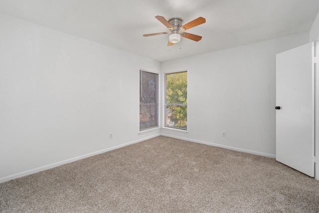 unfurnished room featuring ceiling fan and carpet