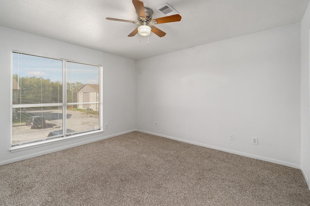 spare room featuring carpet flooring and ceiling fan