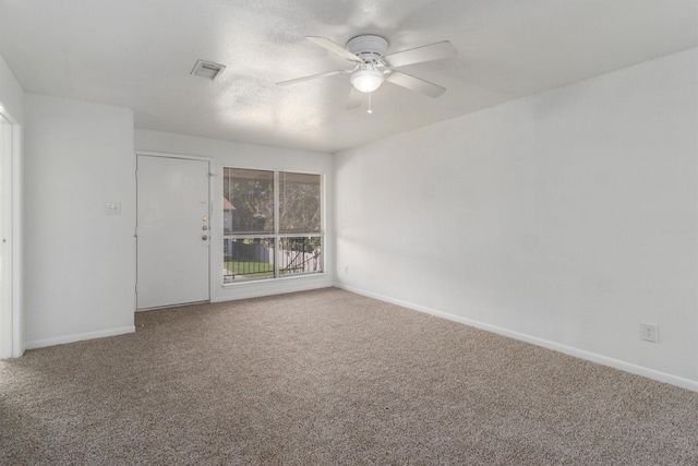 carpeted spare room with ceiling fan