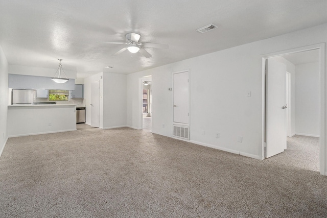 unfurnished living room with a textured ceiling and ceiling fan