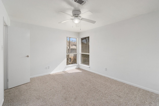 spare room featuring carpet flooring and ceiling fan