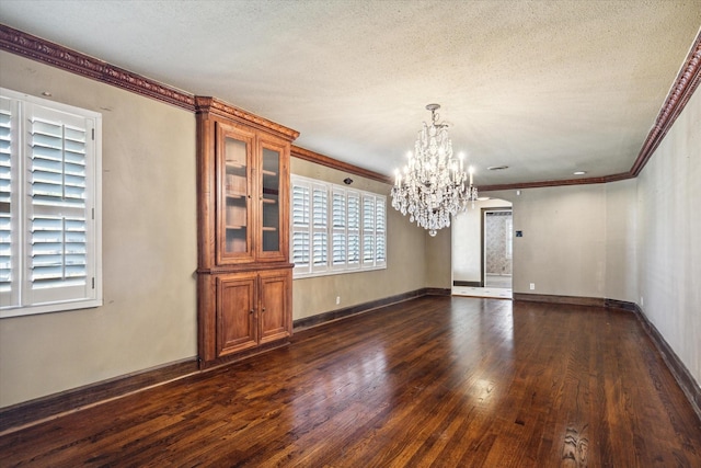 unfurnished dining area with crown molding, dark hardwood / wood-style flooring, and a textured ceiling