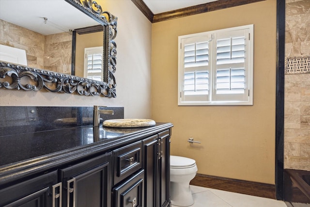 bathroom featuring tile patterned floors, vanity, a healthy amount of sunlight, and toilet